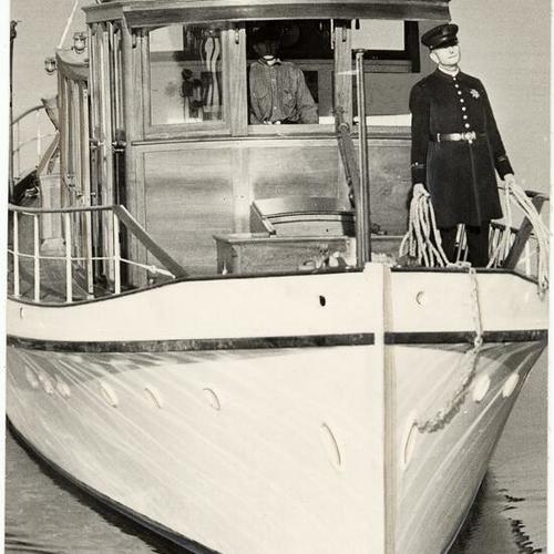 [Policemen conducting search on patrol boat]