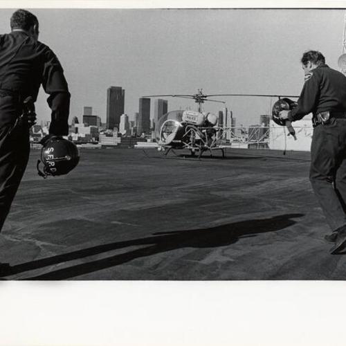 [Policemen approaching San Francisco Police Department helicopter]