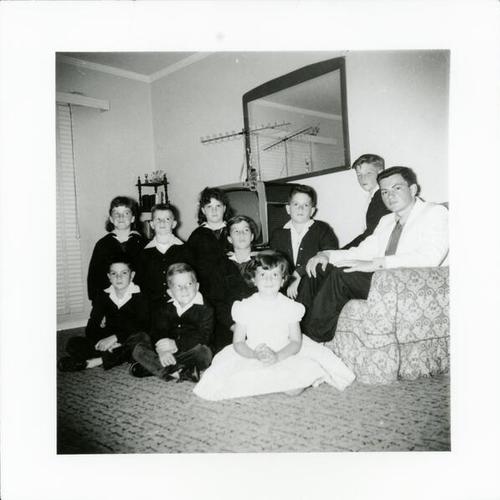 [Ellen's aunts and uncles, including three sets of twins, in living room]