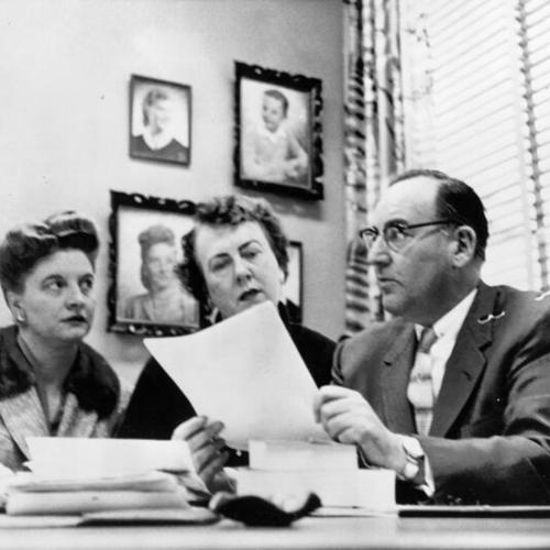 [Edmund G. Brown confers with Mrs. Pauline Davis, left, of Portola, and Dorothy M. Donahoe of Bakersfield]