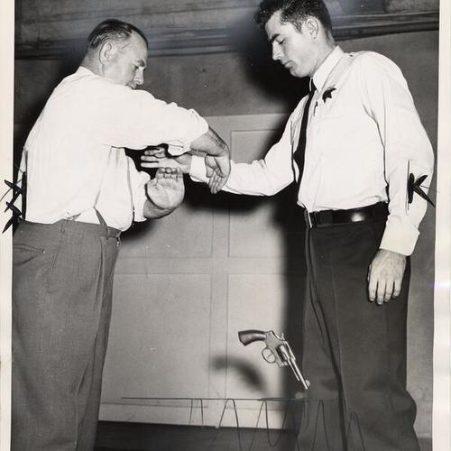 [Officer Epting demonstrates to recruit McCormack the proper way to disarm a gunman]