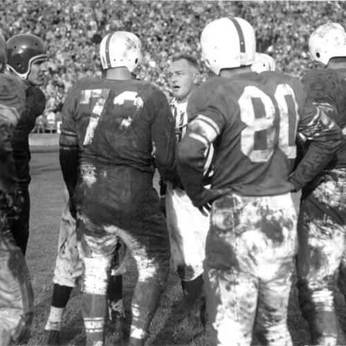 [Umpire Bill Fischer talking to players during a football game at Kezar Stadium]