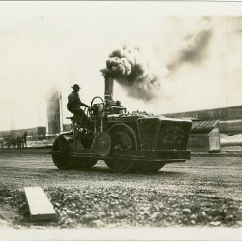 [Steam roller operating in front of the Palace of Machinery during construction of the Panama-Pacific International Exposition]