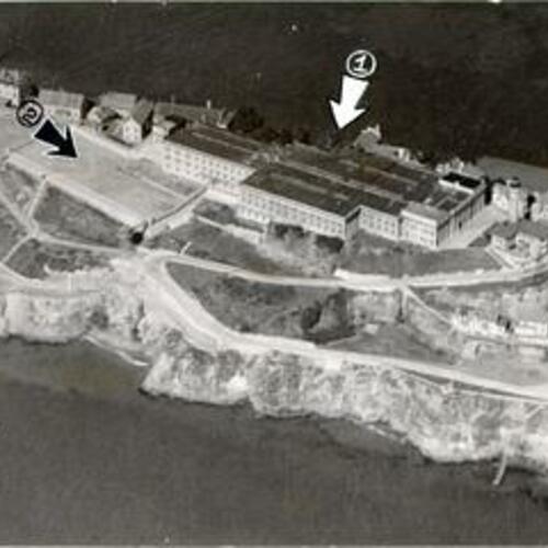 [Aerial view of Alcatraz Island Federal Penitentiary with arrows showing where a group of prisoners tried to escape]