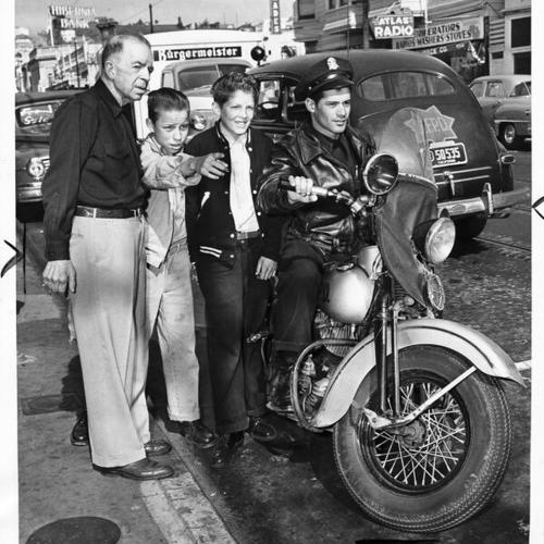 [Officer Anthony Troche on his motorcycle talking with Mr. Fred Bales, Floyd Burdette, and Gerald Felix]