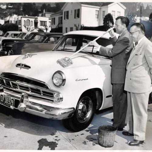 [Vic Martin and Frank Sherman of S & M Motors testing out a "car mop"]