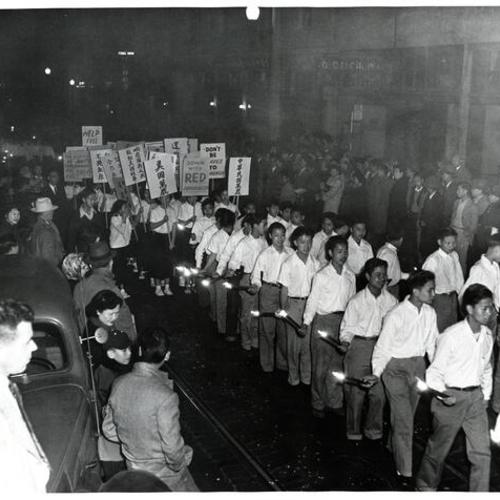 [People marching in Chinatown during festival]