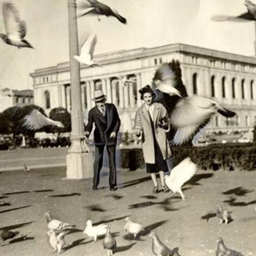 [Juliet Eiden and Gordon Elwell feeding pigeons in the Civic Center]