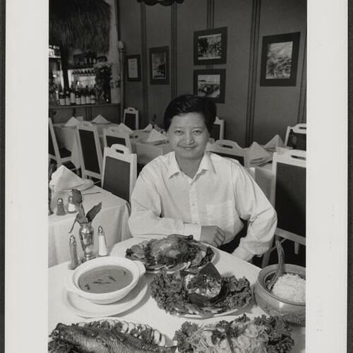 Phnom Penh owner Sonally Kong sitting at table in his restaurant at 631 Larkin Street