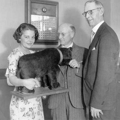 [Gertrude McCabe presenting members of the Royal Knights of the Round Table with a stuffed bear during a visit to Mission High School]