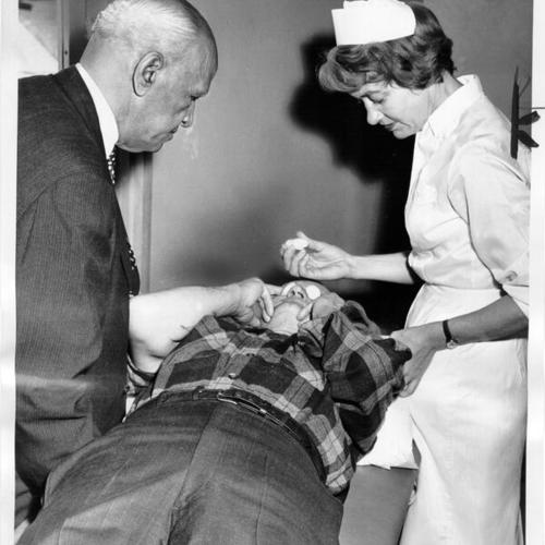 [Hans C. Christensen undergoes eye examination at Kaiser Hospital]
