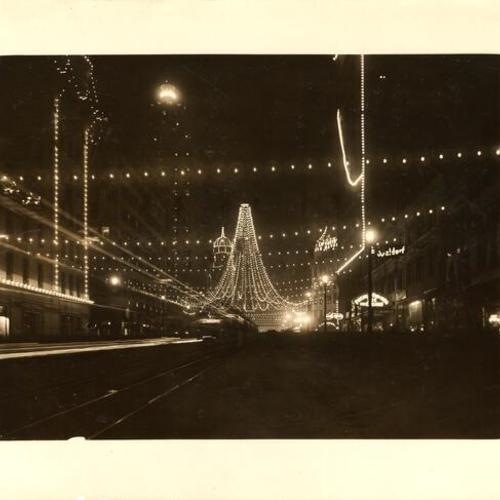 [Intersection of Market and Third streets, where 25,000 colored lights were suspended to form a gigantic bell, Portola Festival, October 19-23, 1909]