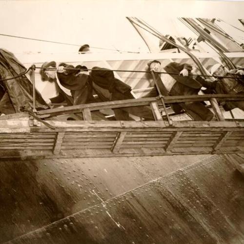 [Group of unidentified men boarding a ship]