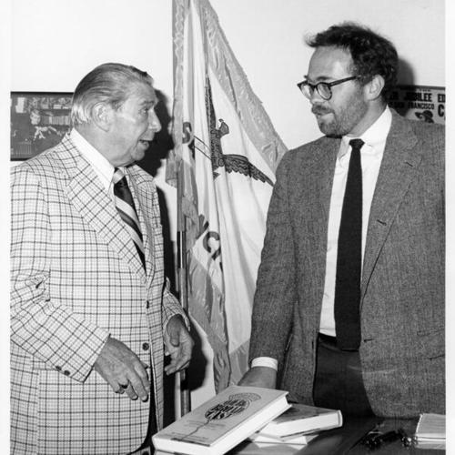 [Harry Von Zell presenting copies of "The Big Broadcast" to City Librarian Kevin Starr]