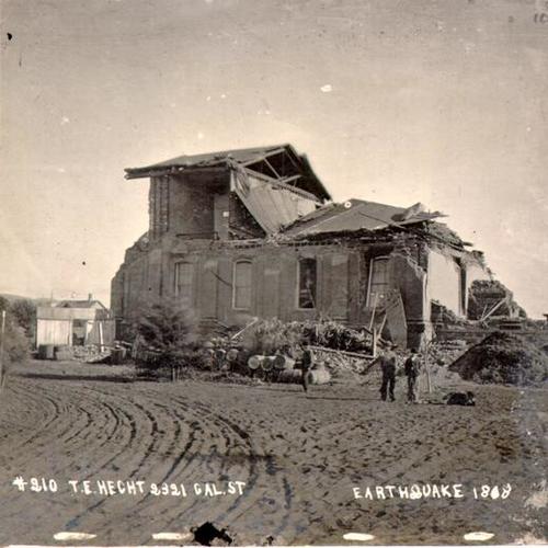 [Four people near the ruins of a building after the 1868 earthquake]