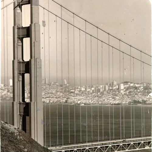 [View of the north tower of the Golden Gate Bridge with San Francisco in the background]