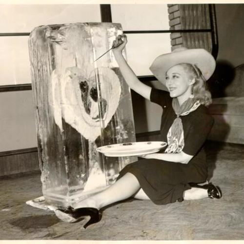[Dancer Sally Rand sitting next to a large block of ice she received as a valentine from the "Boys of Butchertown"]