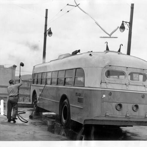 [Municipal Railway trackless trolley 'E' line, car number 510 being washed]