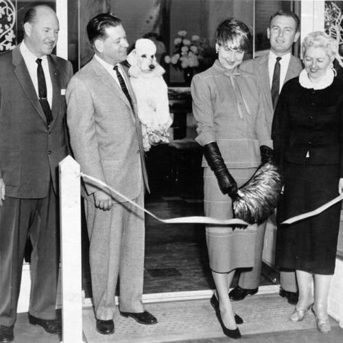 [Mrs. Henry Stoneson cutting the ribbon at the opening of the Casual Aire Shop in Stonestown Shopping Center]