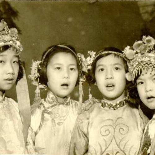 [Four young girls singing in costume]