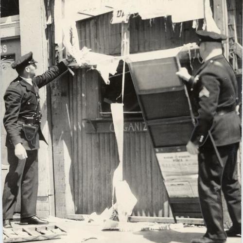 [Police raiding a communist book store at 121 Haight Street]