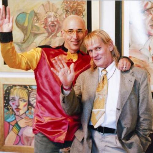 [David Weissman and John Flowers in front of John's art work]