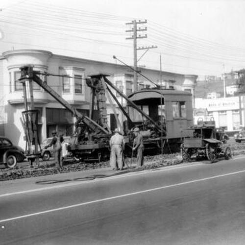 [Bayshore boulevard south of Arleta street showing Derrick car 0131 tearing up track in front of Bay Shore Theater]
