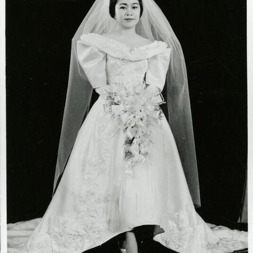 [Mirlanda, as a bride, wearing a typical Filipino wedding gown, a terno dress with butterfly sleeves]