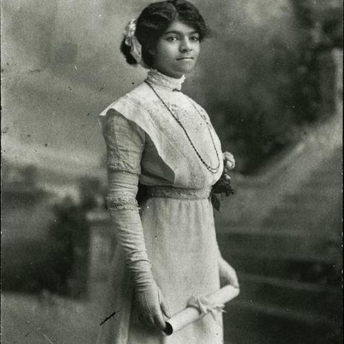 [Anita posing for a studio photo in Oakland for her high school graduation]