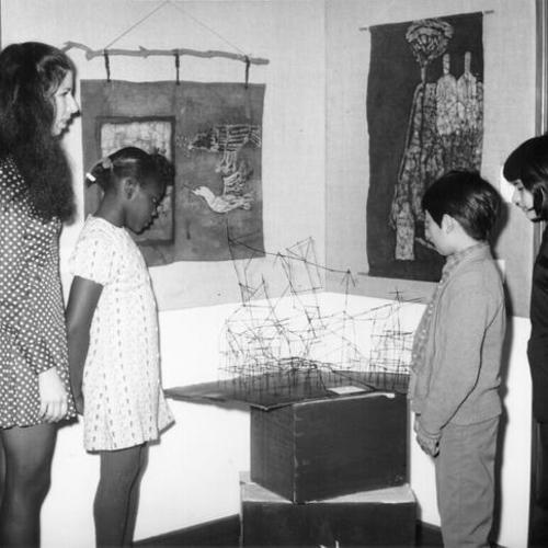 [Four people looking at works of art at Buena Vista School]