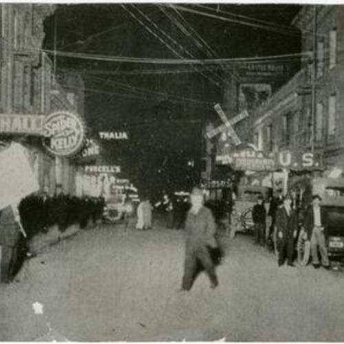 [Busy nighttime street scene on Pacific Street in the Barbary Coast district]