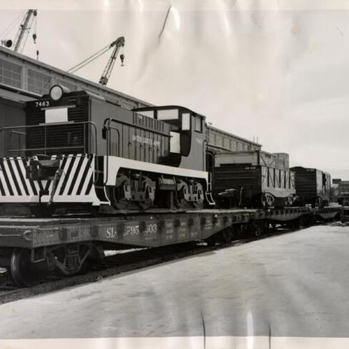 [Large scale model of a Transportation Corps train loaded onto a train at the San Francisco waterfront for shipment to the National Railroad Fair in Chicago]