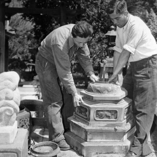 [George Hagiwara and Sakoye Antoko crate a valuable bronze antique from the Japanese Tea Garden in Golden Gate Park]