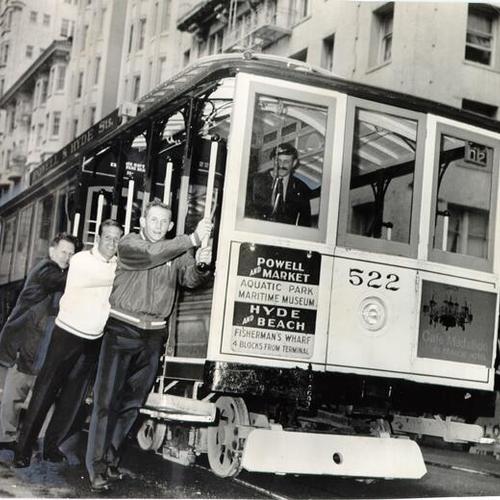 [John Conover, Harvey Morley and Jim Hilbun pushing a Powell and Hyde streets line cable car]