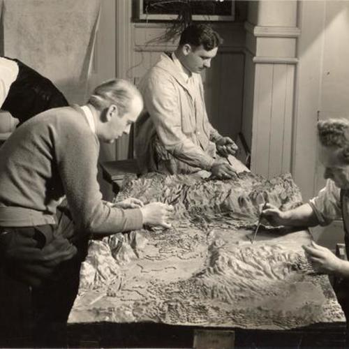 [SERA workers constructing a map]