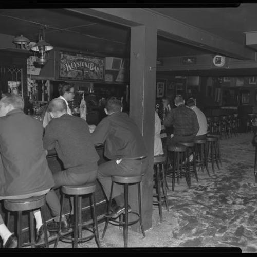 View of bar interior with people seated