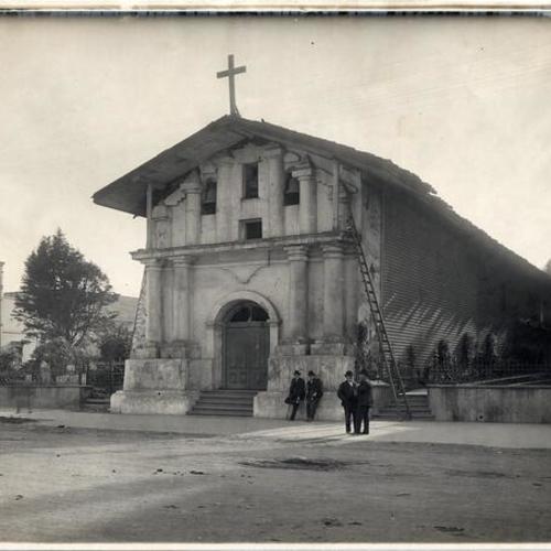 [Four unidentified men standing in front of Mission Dolores]