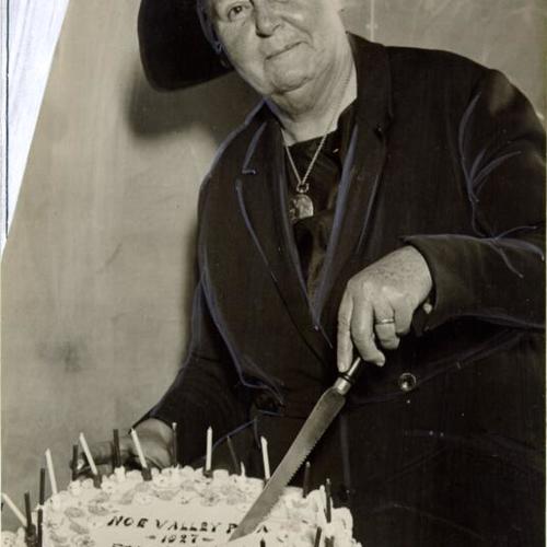 [Woman cutting into a cake, Noe Valley Founders Day]