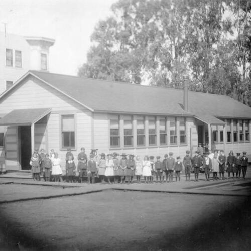 [Children posing for picture outside Andrew Jackson Elementary School]
