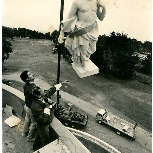 [Cousin of Manual Palos lowering a statue carved by Manuel Palos of a mythological figure into place at the Legion of Honor]