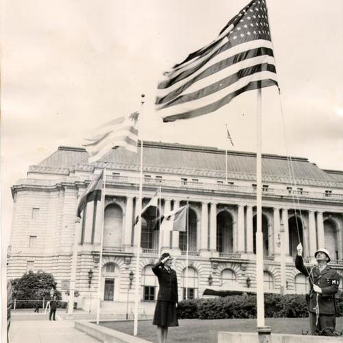 [Rosemary Wetmore saluting the American flag outside of the War Memorial Veterans Building]