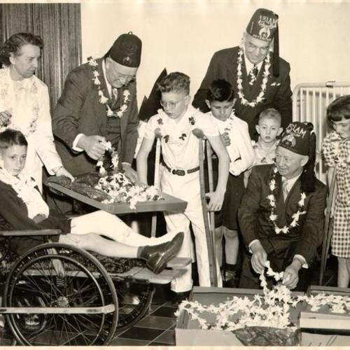 [Shriners visiting patients at the Shriners' Hospital for Crippled Children]