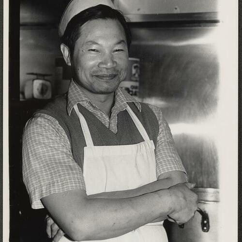 Cook wearing hat and apron in kitchen