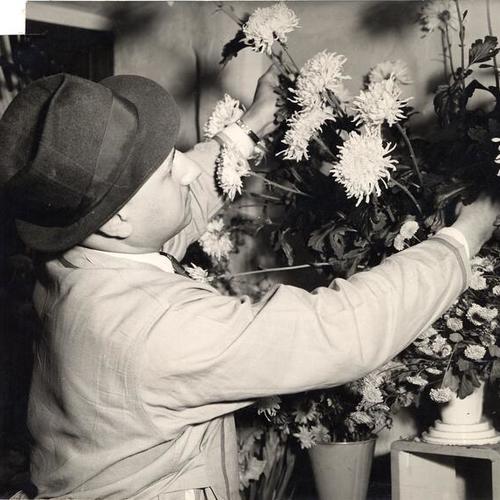 [Man working in a flower shop]