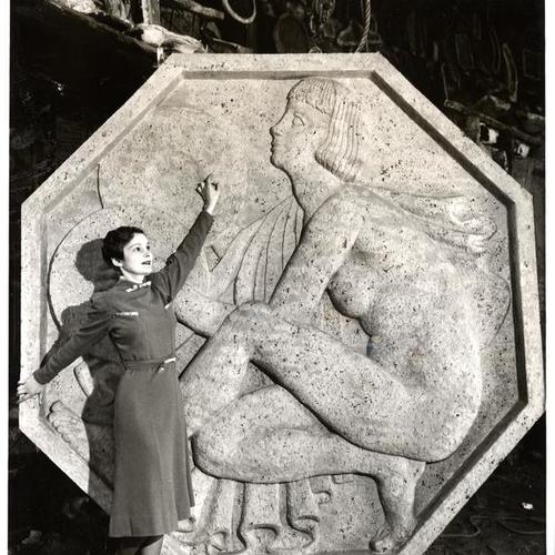 [Maxine Upham appraising bas relief "Music" by artist Michael von Meyer, Golden Gate International Exposition on Treasure Island]