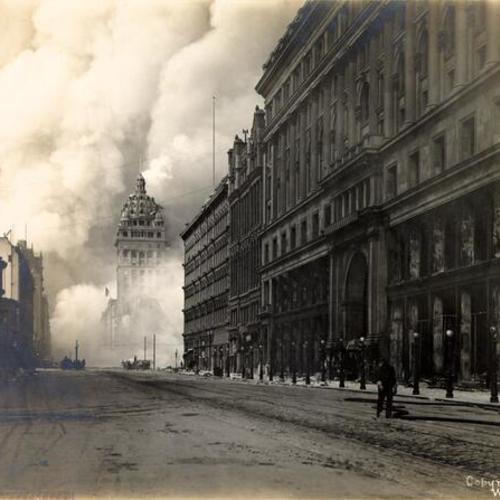 [View of fires burning on Market Street, looking east from the Emporium, with Call Building in distance]