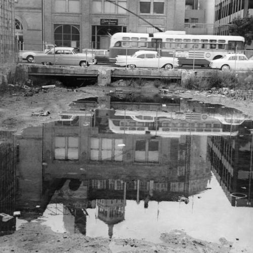 [Pool of water in a vacant lot on Sacramento and Drumm Street]