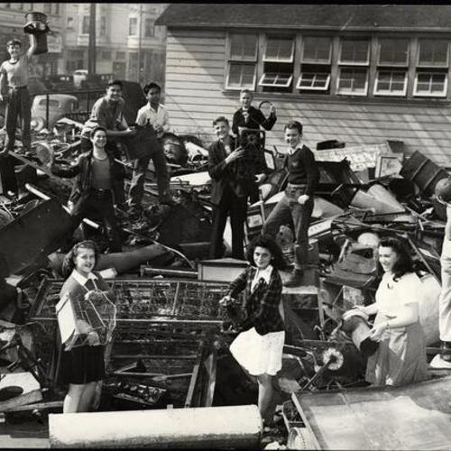 [Students standing in a scrap pile on the grounds of John Swett School]