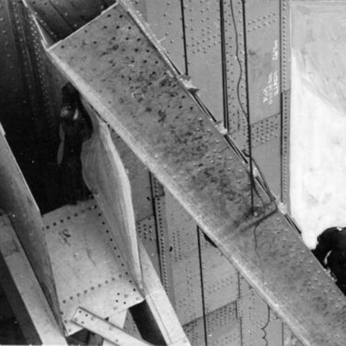 [Construction worker guides girder into place during Golden Gate Bridge Marin tower construction]