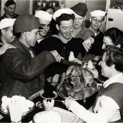 [Service men enjoying the turkey Christmas at the American Women's Voluntary Services (AWVS) Third and Townsend sts. canteen]